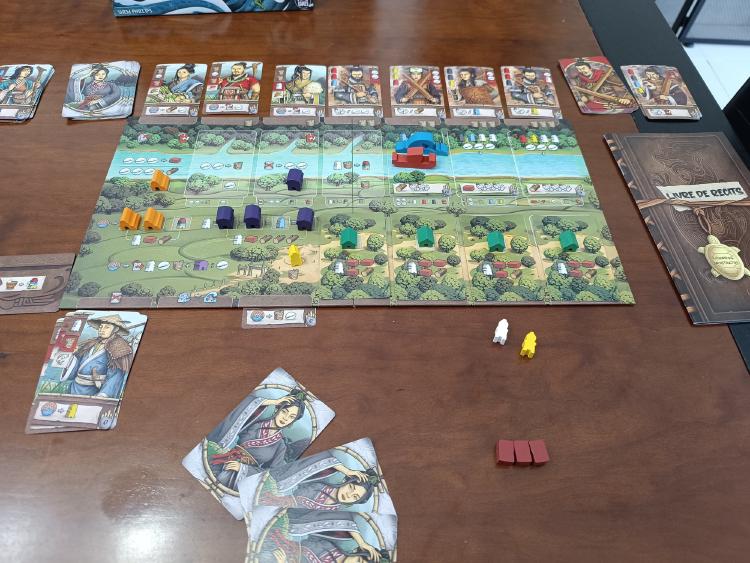 Legacy of Yu game in progress with cards in hand and Story Book visible on the right