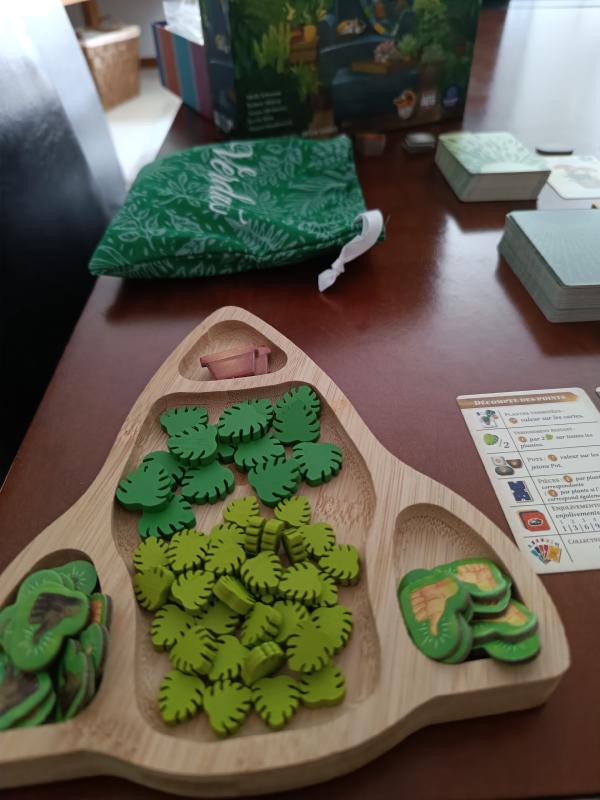 Close-up of Verdant's wooden verdancy tokens and pot tokens arranged in the wooden component tray, with the scoring card beside them