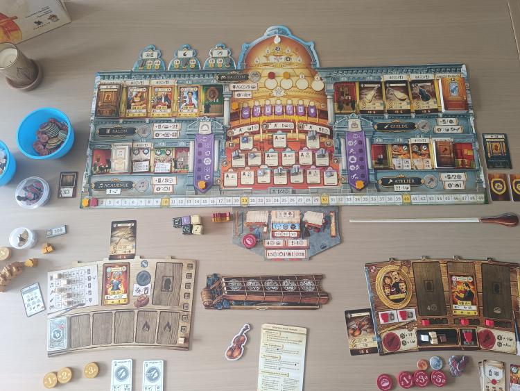 French edition of Luthier set up on the table, showing the instrument shop boards, guild, academy and workshop sections with wooden components
