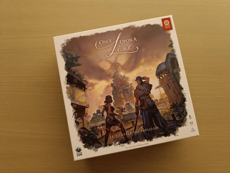 Once Upon a Line box on a wooden table, showing the cover art for Le Souffle du Papillon