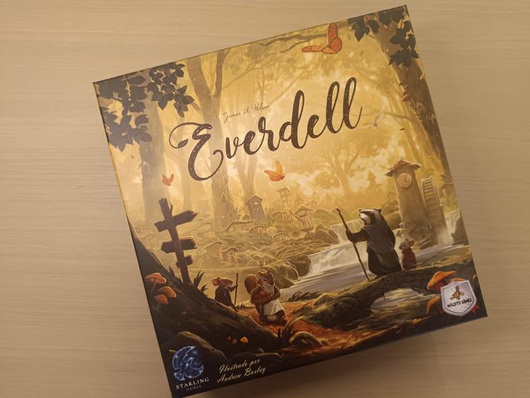 Everdell box cover with a badger and mice in a golden forest