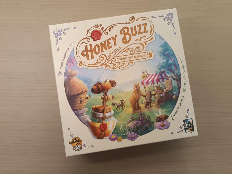 Honey Buzz box cover with bees, a bear and a honey market