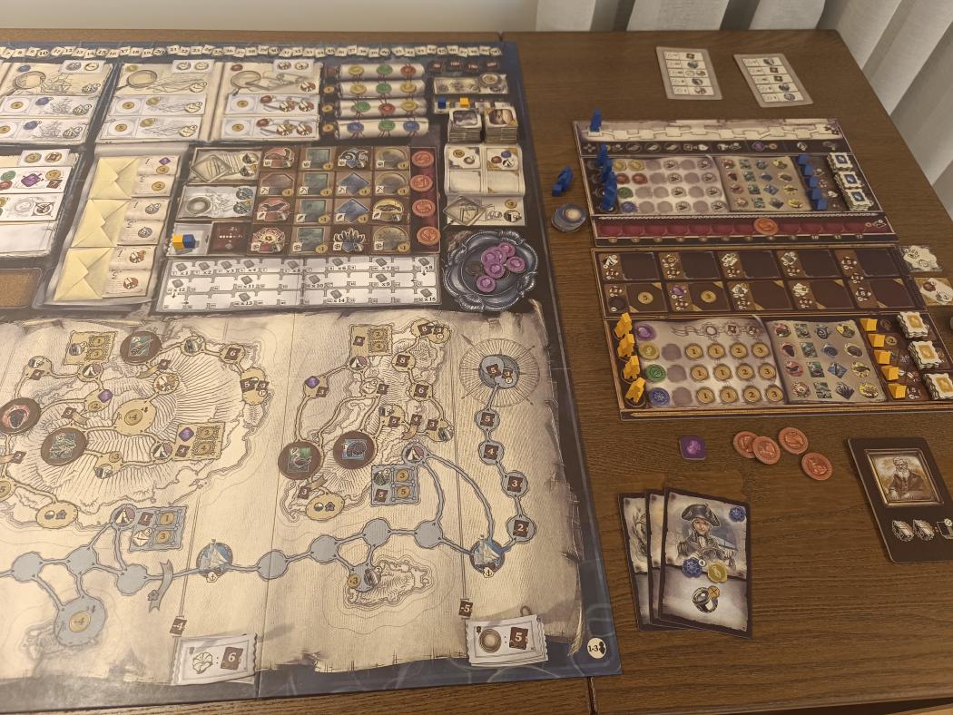 Darwin's Journey main board with the island map, letters and specimen areas, next to two player boards with blue and yellow workers