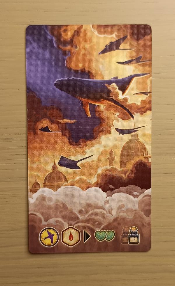 An Unconscious Mind dream card showing a whale flying through orange and purple clouds above a domed city